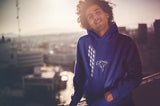 This navy hoodie is soft, smooth and stylish. It is the perfect choice for the cooler evenings, the early morning jump of when you want a bit extra. It has soft cotton faced fabric, double fabric hood with self colour drawstring and front pouch pocket. It has a building and 'send it' shaped as a parachute printed on front.