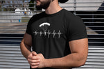 This black unisex t-shirt with white print  is everything you have dreamed of and more. It feels soft and lightweight with the right amount of stretch. It is comfortable and flattering for both men and women and with heartbeat with a skydiver print on the front. Available in several colours.