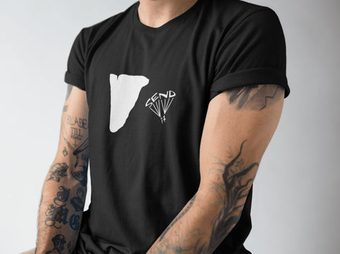 This black unisex t-shirt is everything you have dreamed of and more. It feels soft and lightweight with the right amount of stretch. It is comfortable and flattering for both men and women and with a cliff and ‘SEND IT’ shaped as a basejumper print on the front. Available in several colours.
